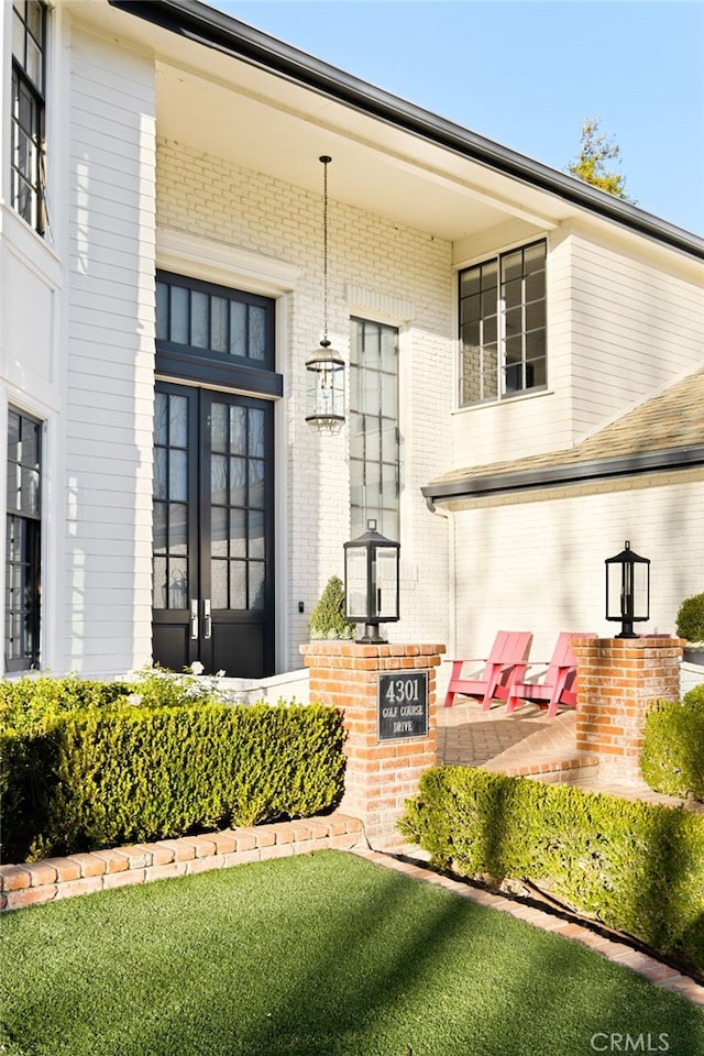 doorway to property featuring a lawn