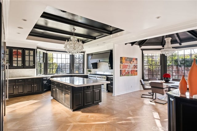 kitchen featuring double oven range, light parquet flooring, a chandelier, and a kitchen island