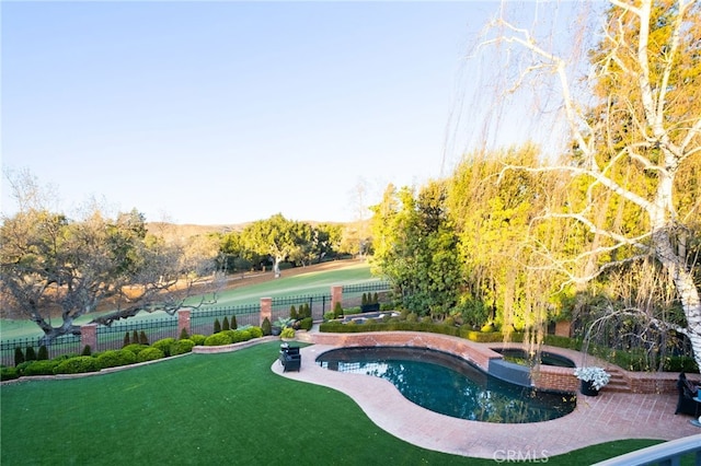 view of swimming pool featuring an in ground hot tub and a lawn