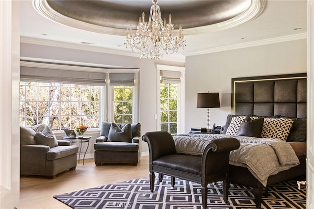 bedroom with crown molding, wood-type flooring, and a raised ceiling