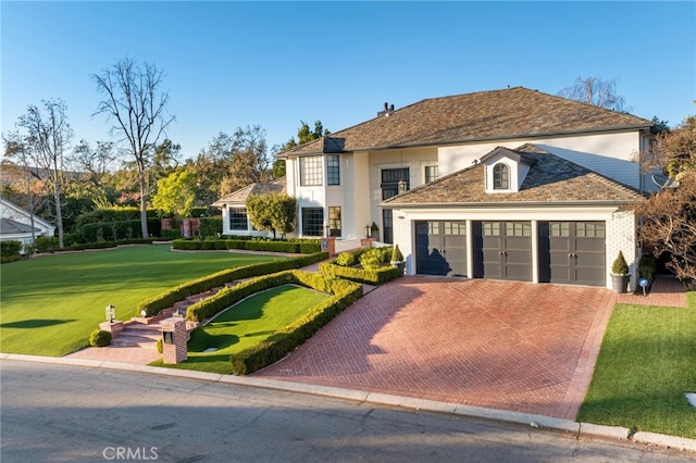 view of front of property featuring a garage and a front lawn