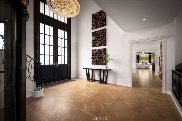 foyer with stairs, a high ceiling, recessed lighting, and baseboards