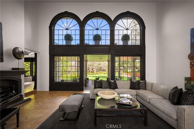 living area featuring a towering ceiling and a fireplace