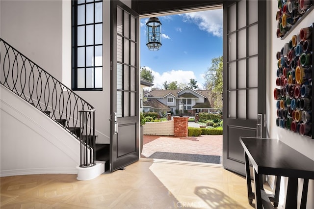foyer entrance with stairs and a notable chandelier