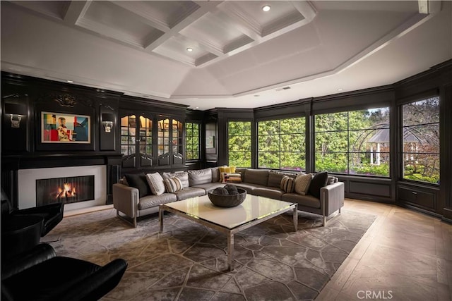 living area featuring visible vents, beamed ceiling, a lit fireplace, recessed lighting, and coffered ceiling
