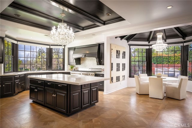 kitchen featuring premium range hood, backsplash, a chandelier, and light countertops