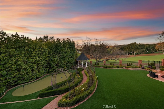 view of community with a yard and fence
