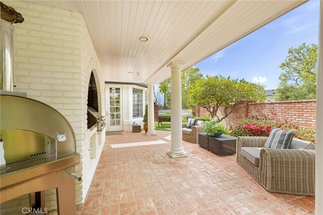 view of patio / terrace with area for grilling, a grill, and fence