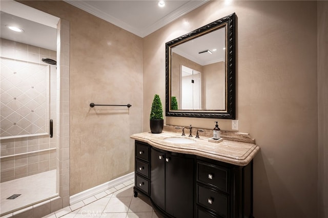 bathroom with tile patterned floors, ornamental molding, a tile shower, baseboards, and vanity
