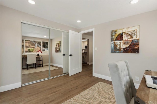 home office with baseboards, wood finished floors, and recessed lighting