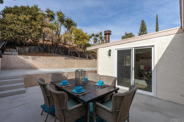 view of patio / terrace featuring outdoor dining area and fence