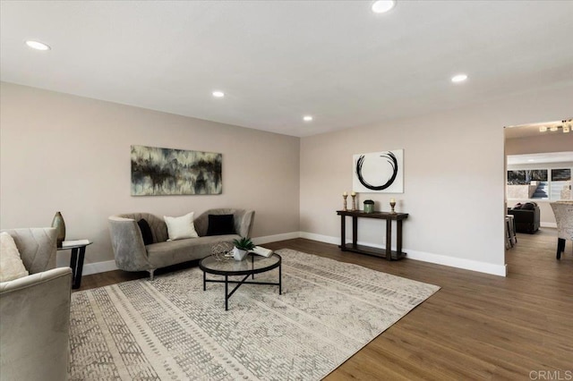 living room with baseboards, wood finished floors, and recessed lighting