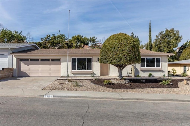 ranch-style house featuring a garage, concrete driveway, and stucco siding