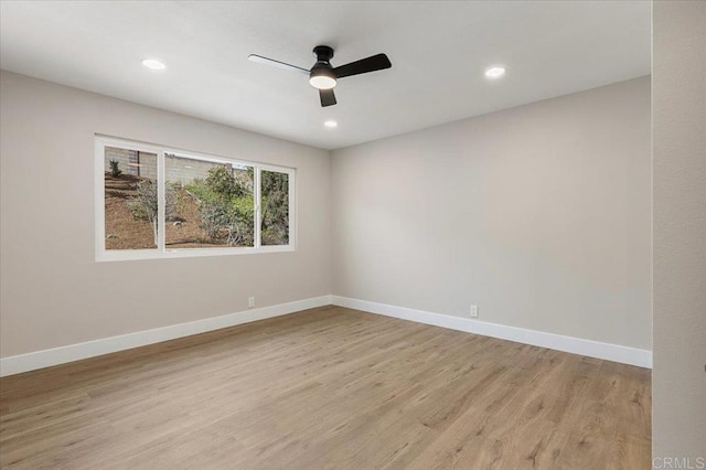 unfurnished room with recessed lighting, light wood-type flooring, a ceiling fan, and baseboards