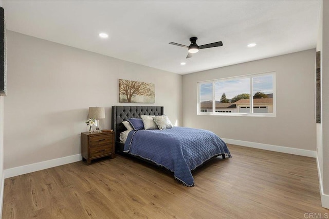 bedroom featuring ceiling fan, recessed lighting, wood finished floors, and baseboards