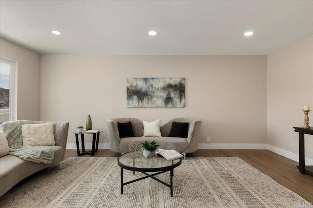 living room with baseboards, wood finished floors, and recessed lighting