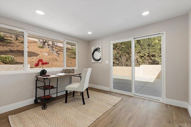 office with light wood finished floors, a wealth of natural light, and baseboards