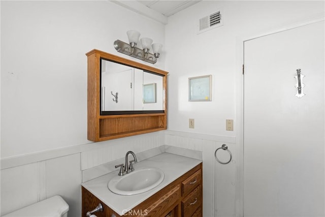 bathroom featuring toilet and vanity