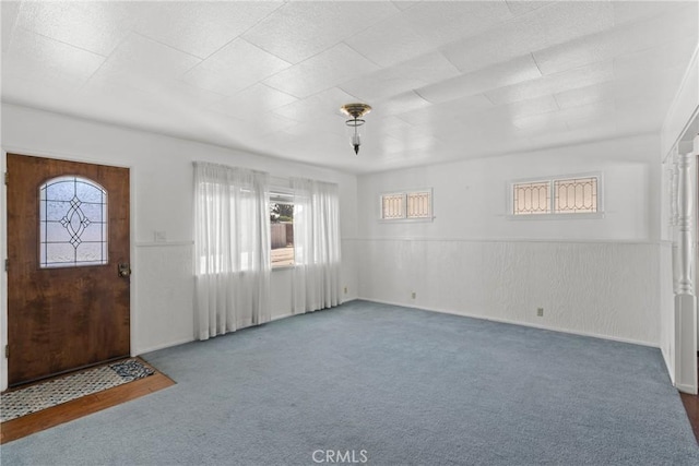 entryway featuring dark colored carpet