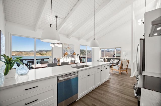 kitchen with dark wood-type flooring, a water view, white cabinetry, appliances with stainless steel finishes, and pendant lighting