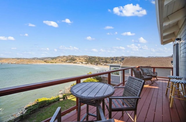 wooden terrace featuring a water view