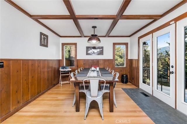 dining space with coffered ceiling, hardwood / wood-style flooring, and beam ceiling