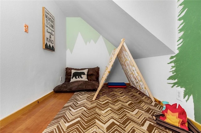 sitting room featuring hardwood / wood-style flooring and lofted ceiling