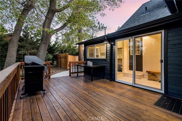 deck at dusk with grilling area