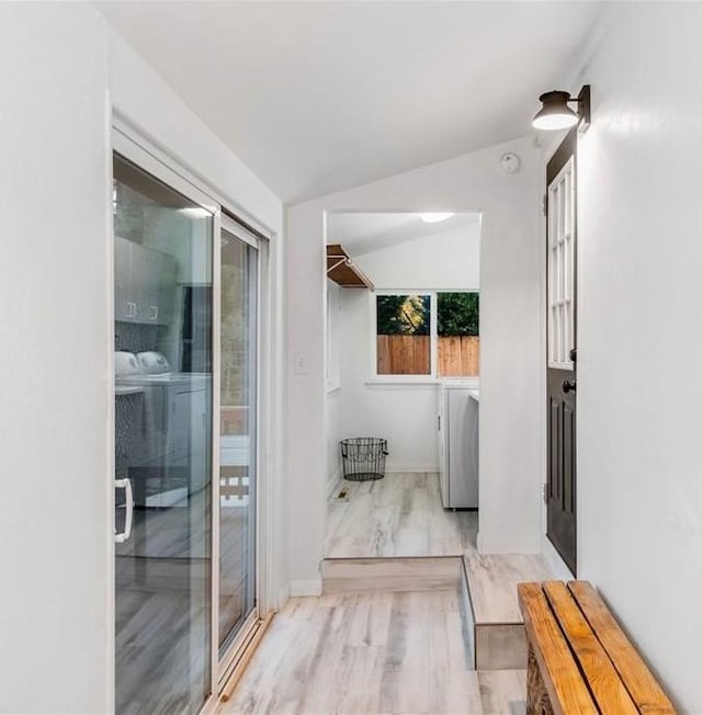 interior space featuring vaulted ceiling and independent washer and dryer