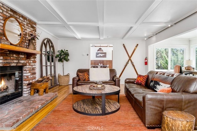 living room featuring coffered ceiling, beamed ceiling, hardwood / wood-style floors, and a fireplace