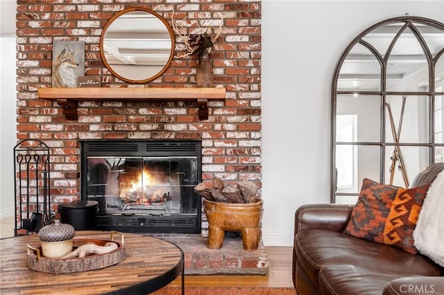 living room with hardwood / wood-style flooring and a brick fireplace