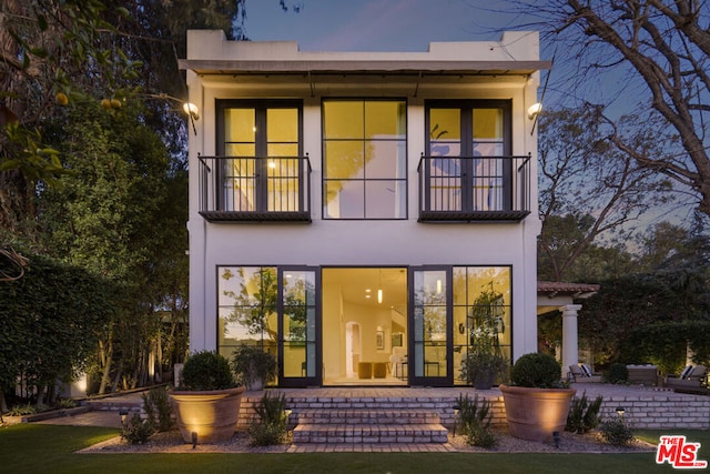 view of front facade featuring a balcony and a patio area