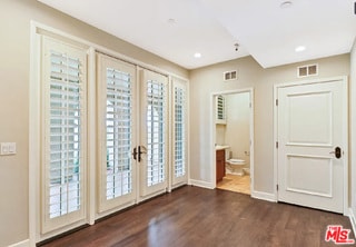 doorway to outside with dark wood-type flooring and french doors