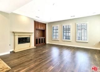 unfurnished living room with dark hardwood / wood-style floors