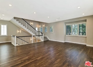 unfurnished living room with dark wood-type flooring