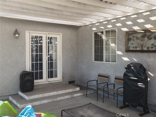 view of patio / terrace featuring a pergola, area for grilling, and french doors