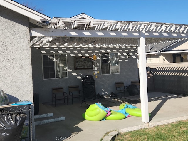 view of patio with grilling area and a pergola