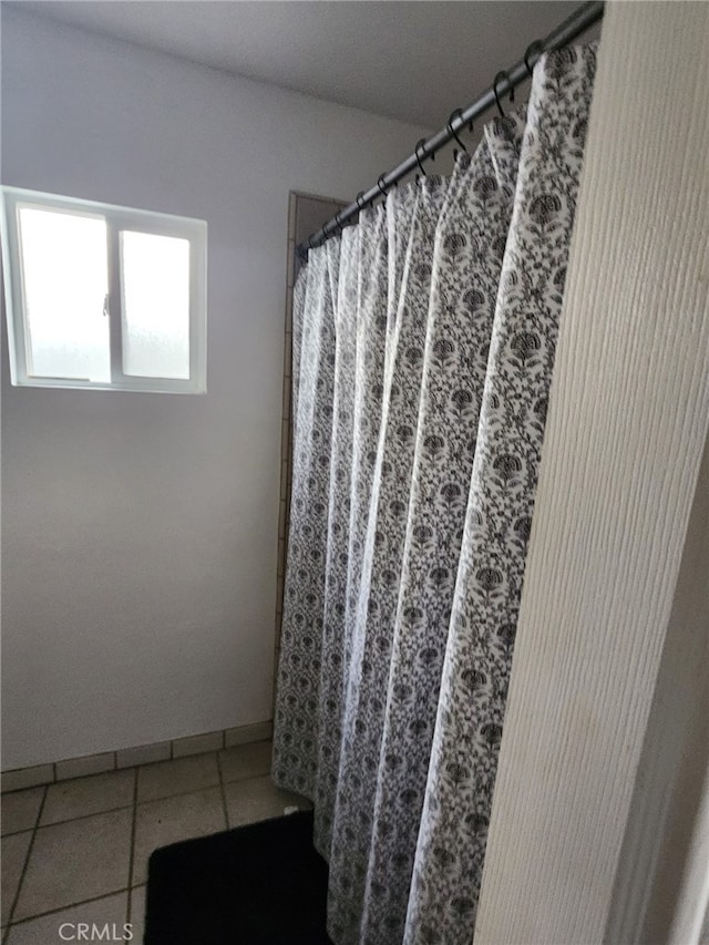 bathroom featuring tile patterned flooring and walk in shower