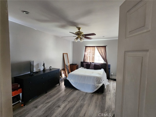 bedroom with hardwood / wood-style flooring and ceiling fan