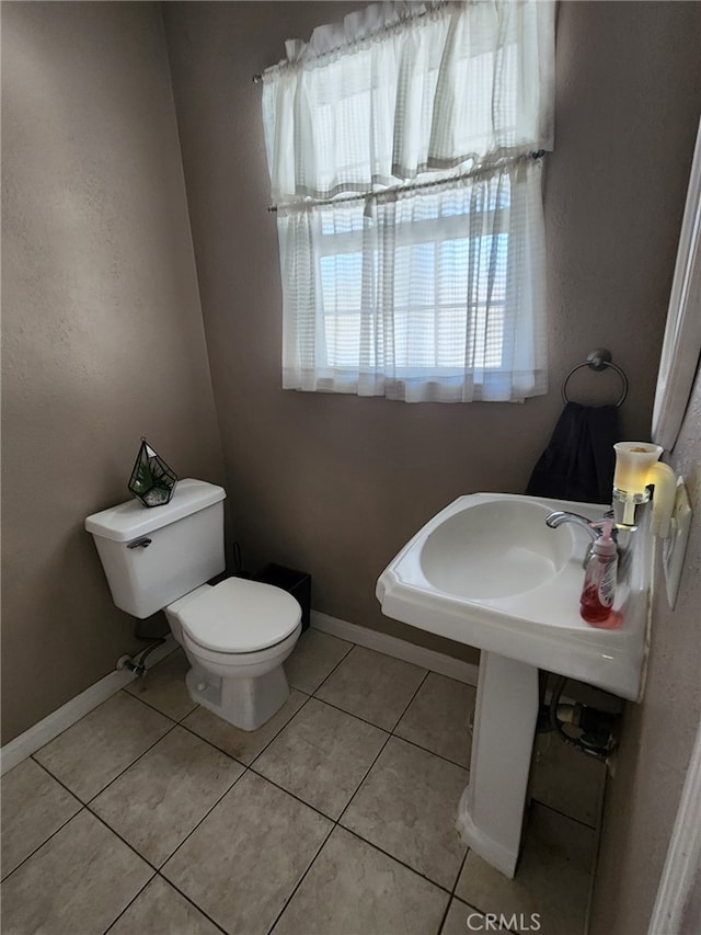 bathroom featuring tile patterned floors and toilet