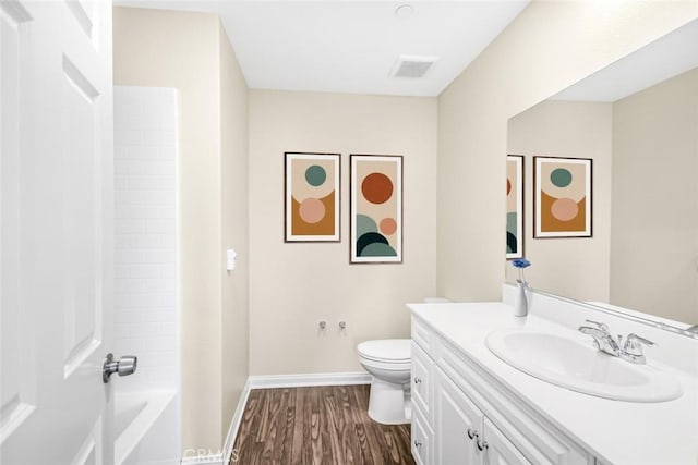 full bathroom with vanity, toilet, shower / bathtub combination, and hardwood / wood-style floors