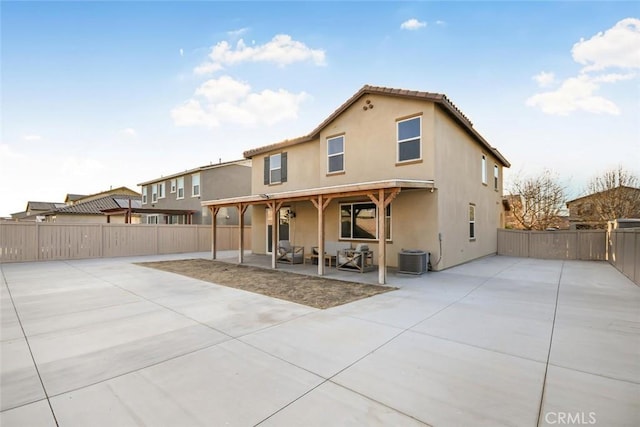 rear view of house with a patio area and central AC unit