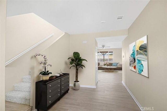 corridor with light hardwood / wood-style floors