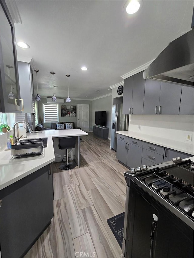 kitchen with kitchen peninsula, pendant lighting, stainless steel fridge with ice dispenser, a breakfast bar, and wall chimney range hood