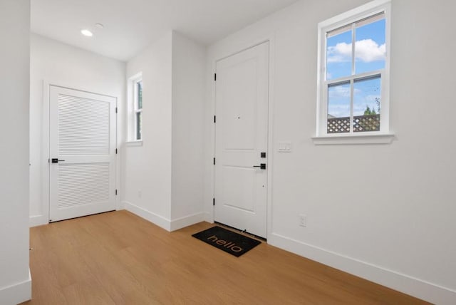 foyer entrance with light hardwood / wood-style floors