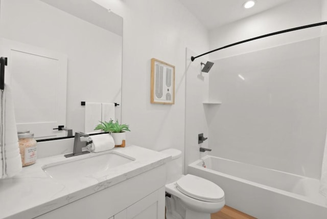 full bathroom with vanity, toilet, shower / bath combination, and hardwood / wood-style floors