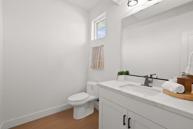 bathroom featuring hardwood / wood-style flooring, vanity, and toilet