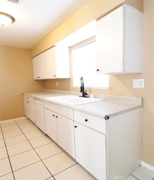 kitchen featuring light tile patterned flooring, dishwasher, sink, and white cabinets