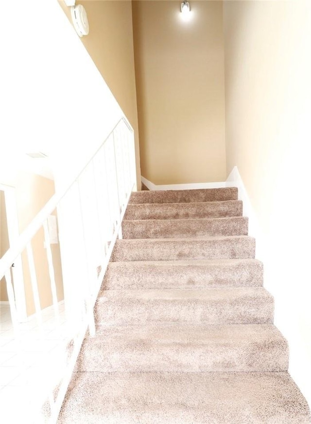 stairs featuring carpet