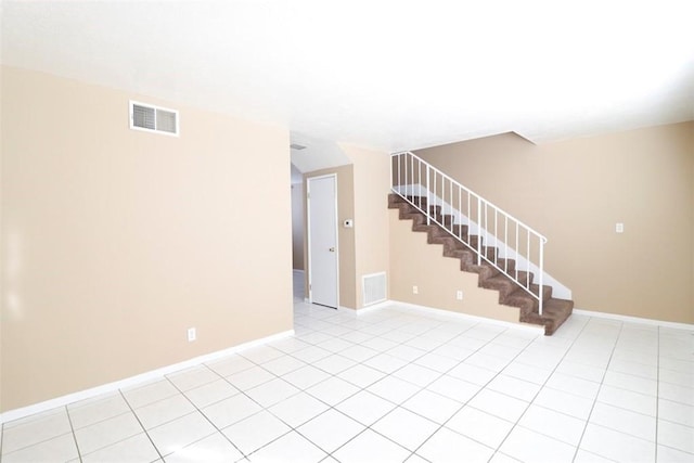 unfurnished room featuring light tile patterned flooring